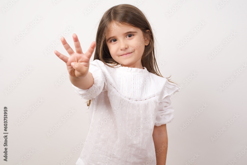 Cute charming little girl wearing white shirt over white background pointing up with fingers number four, fourth. Cute charming little girl wearing white shirt over white background pointing up with fingers number four, fourth.