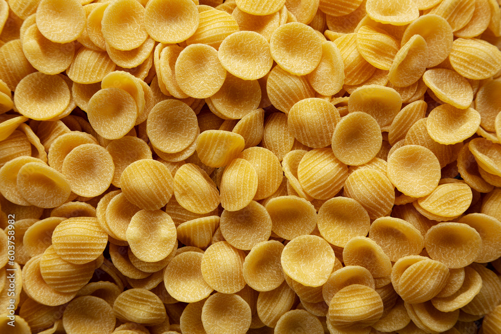 Dry, Uncooked Orecchiette Pasta Background Dry, Uncooked Orecchiette Pasta Background