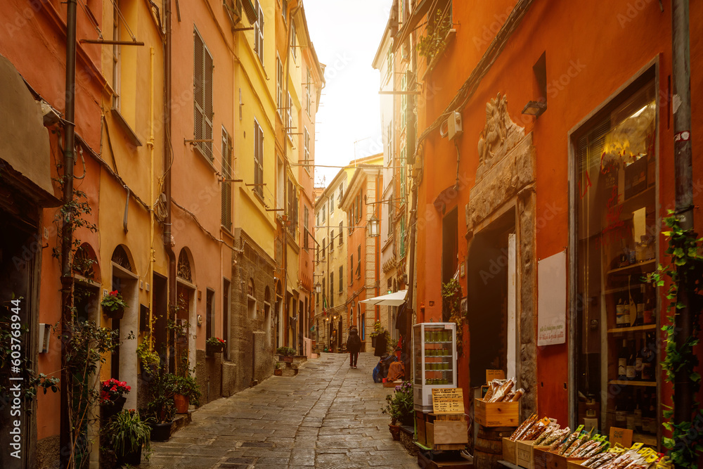 Yellow and red bright houses on narrow traditional streets of an Italian town.