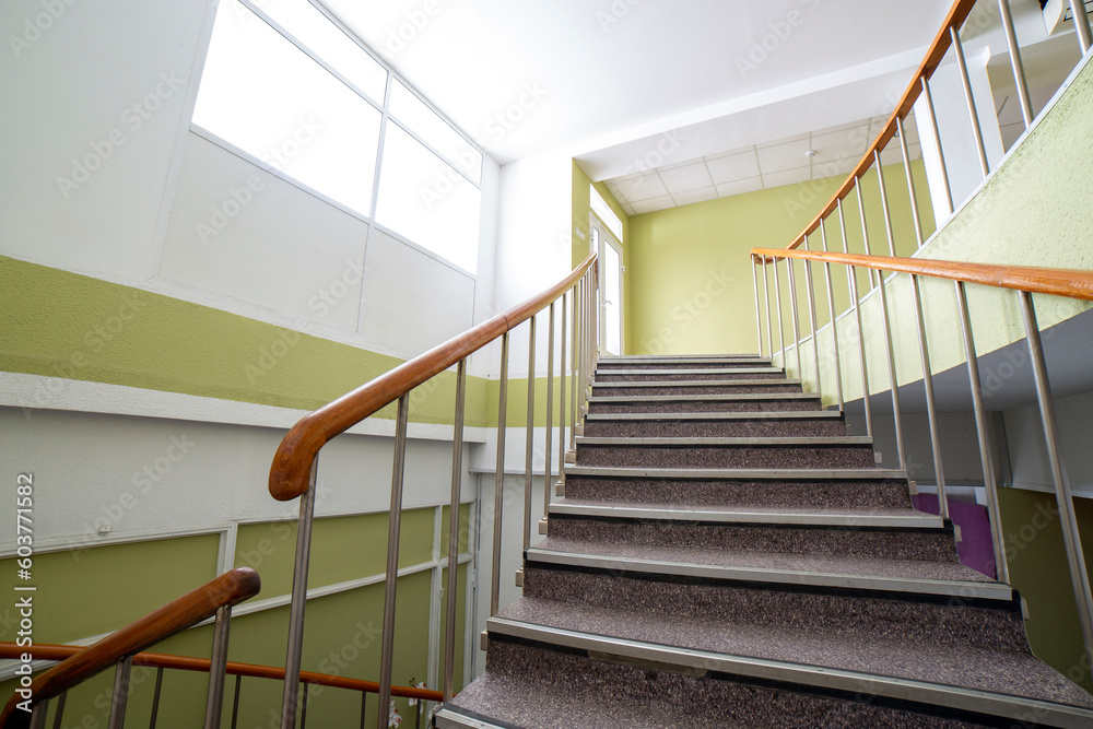 A fragment of the interior with a staircase to the second floor in a residential building A fragment of the interior with a staircase to the second floor in a residential building