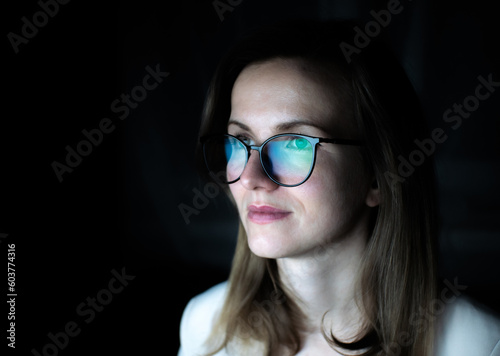 Business woman in glasses is working online at the laptop or computer. Social media influencer creating content. Programmer or designer work. Marketing and stock market.
