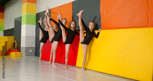 Little girls practice at gymnastics class in a studio