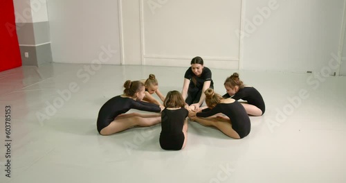 Little girls practice at gymnastics class in a studio