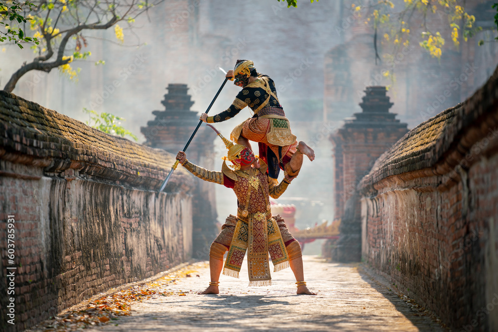 Khon or traditional Thai classic masked from the Ramakien characters action of traditional dance with fighting position and Thai ancient building in background. Khon or traditional Thai classic masked from the Ramakien characters action of traditional dance with fighting position and Thai ancient building in background.