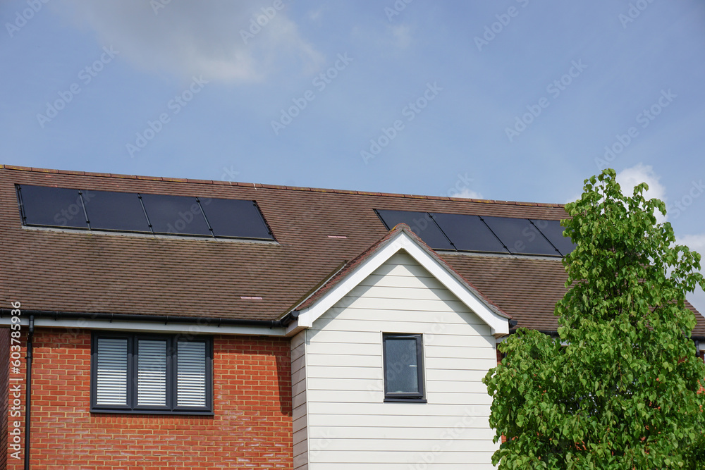 residential property rooftop with solar cell panels. 