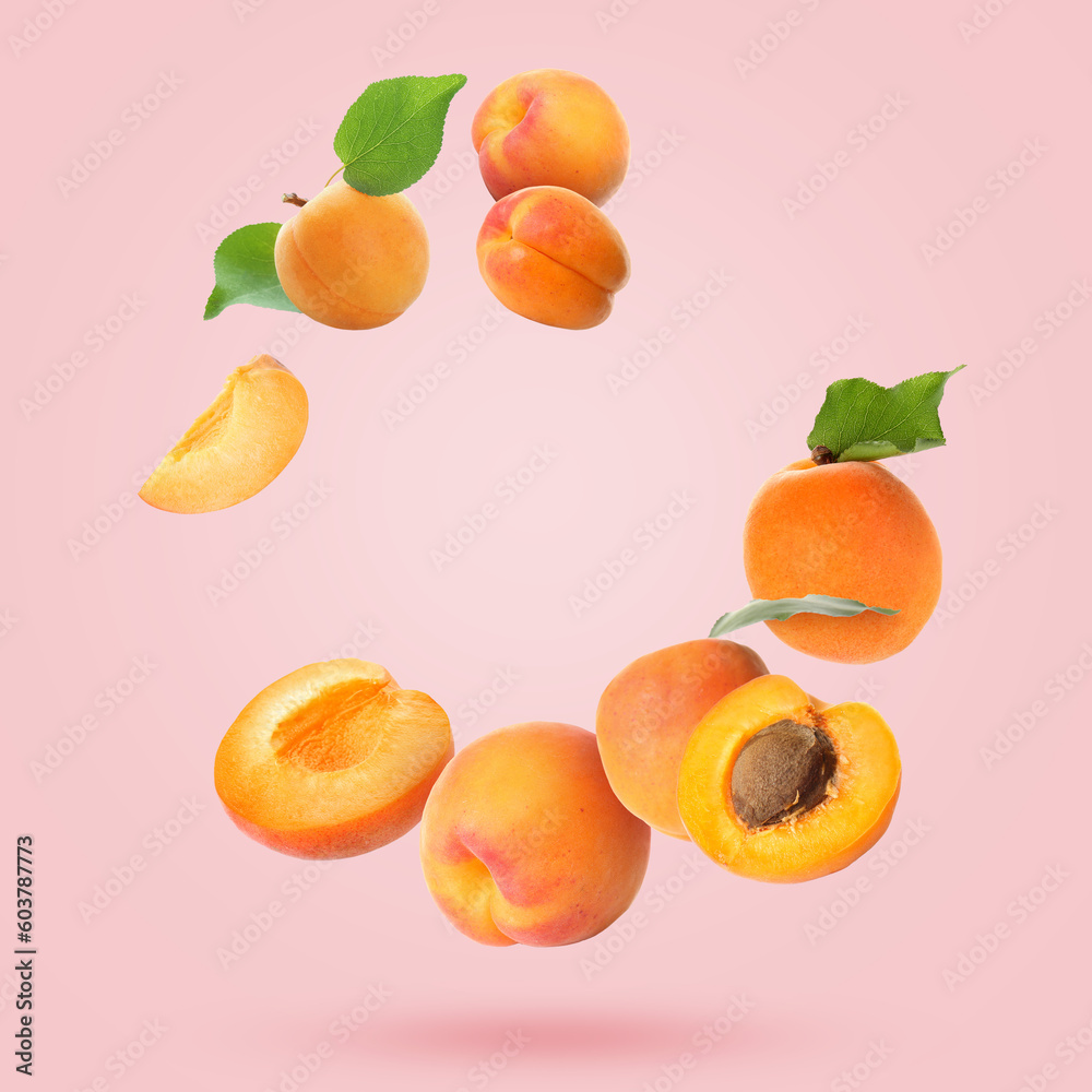 Flying apricots on pink background Flying apricots on pink background