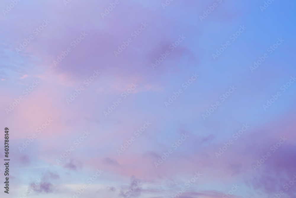 Obraz premium Twilight sky with effect of light in pastel pink, coral, orange, blue tones. Colorful sunset of soft clouds. Background