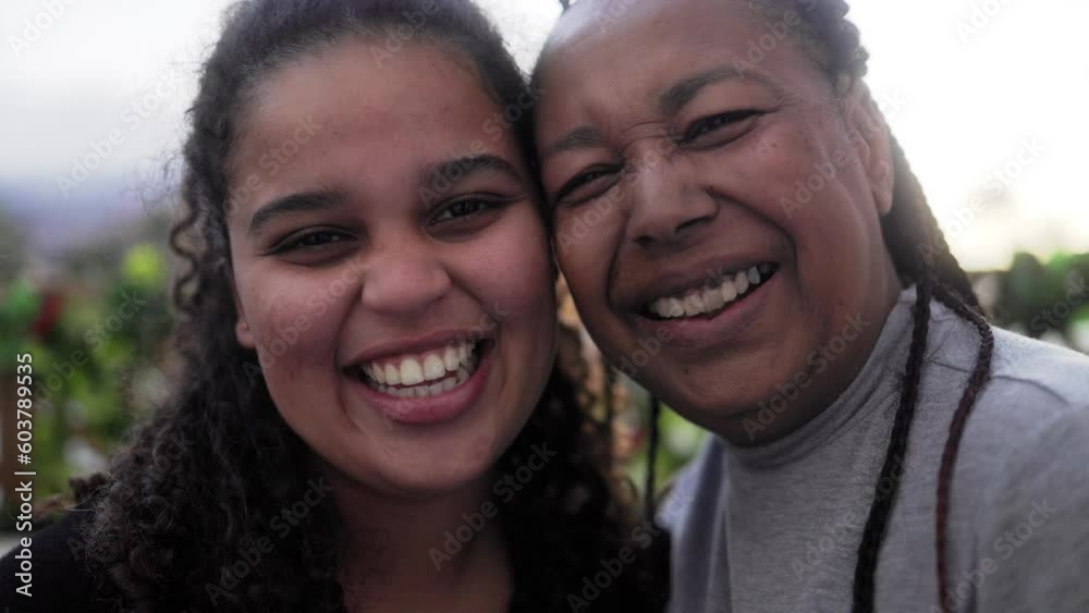 Portrait of happy African mother and daughter having fun outdoor smiling at camera - Love family concept Portrait of happy African mother and daughter having fun outdoor smiling at camera - Love family concept