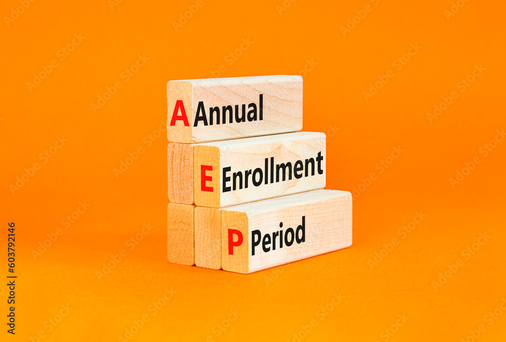Naklejka premium AEP symbol. Concept words AEP Annual enrollment period on beautiful wooden block. Beautiful orange table orange background. Medical and AEP Annual enrollment period concept. Copy space.