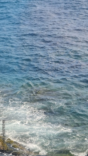 Genova, Italy - May 11, 2023: Beautifull seascape in spring. Blue sky hot weather and calm sea. Mediteranean seascape colours. Small waves near the rocks.