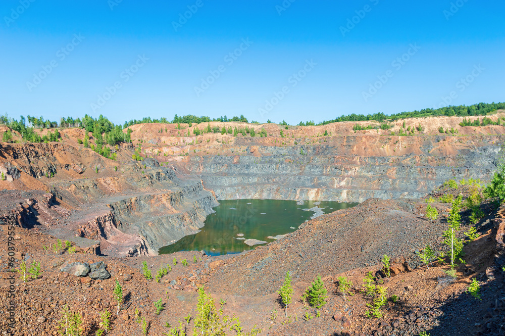 Abandoned Stone Quarry with a Lake at the Bottom Abandoned Stone Quarry with a Lake at the Bottom