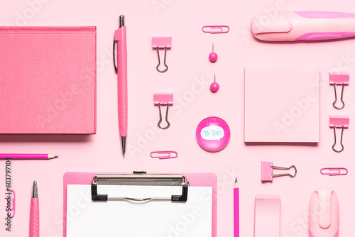 Pink stationery set on light pink background. Seamless pattern, top view. Back to school background. Creative office desktop.