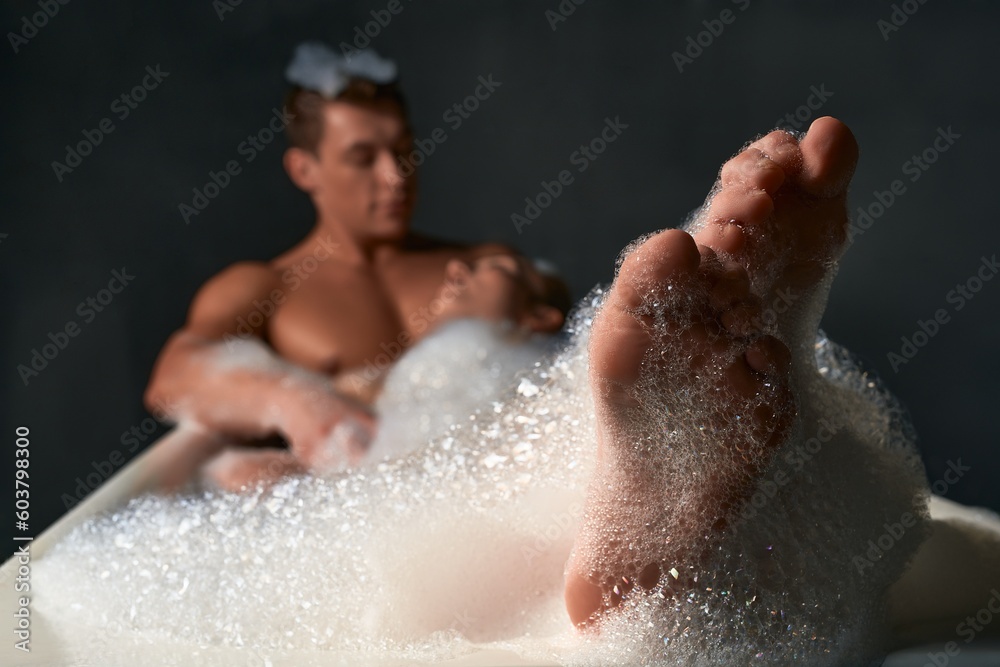 Happy couple relaxing in bathtub