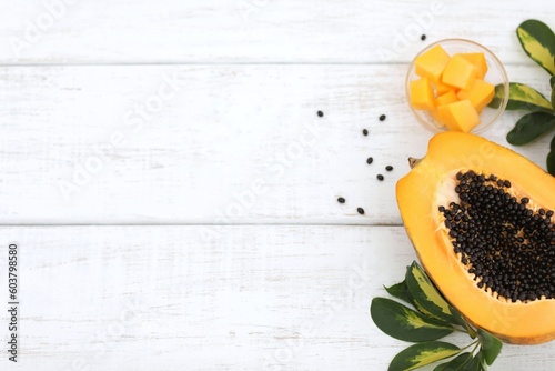 Papaya, papaya, on a white table, exotic fruit, tropical plant, consumption, preparation, healthy food, background, background image, vitamins, green leaves photo