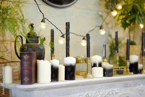 Decorations set made from candles, lanterns and plants and other accessories are on the shelf at the reception of a hotel, restaurant or at a wedding party.