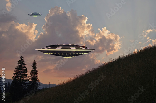 UFO  space saucer flying in the sky over high mountains. Landscape with an invasion by an extraterrestrial space object in summer