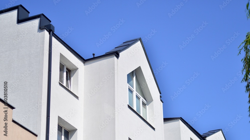Apartment building with bright facades. Modern minimalist architecture with lots of square glass windows and balconies. Apartment building with bright facades. Modern minimalist architecture with lots of square glass windows and balconies.