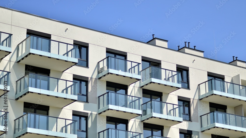 Apartment building with bright facades. Modern minimalist architecture with lots of square glass windows and balconies.