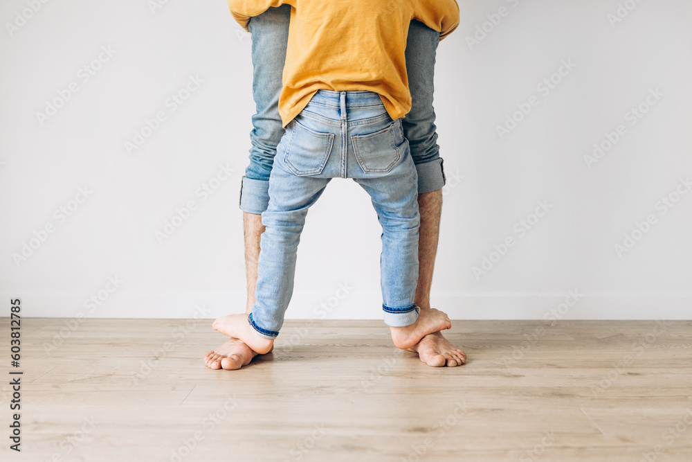 Happy father and son playing at home. Concept of friendly family Happy father and son playing at home. Concept of friendly family