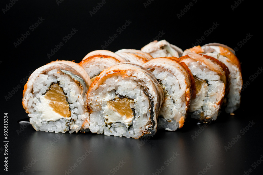 Close up view of Japanese traditional sushi roll with salmon, smoked eel, philadelphia cheese Close up view of Japanese traditional sushi roll with salmon, smoked eel, philadelphia cheese