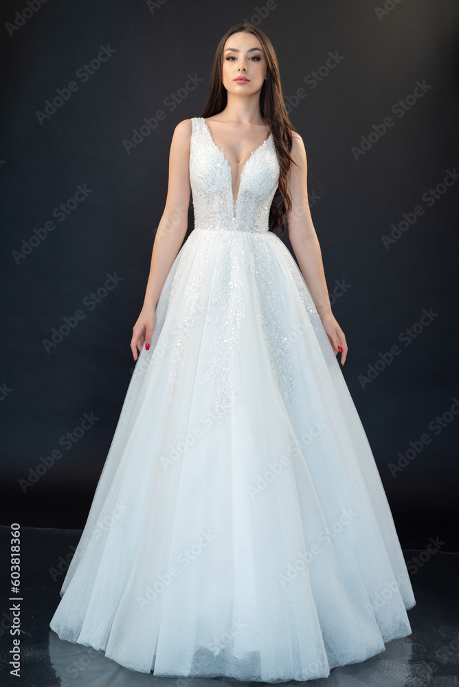 Beautiful bride in wedding dress on black background Beautiful bride in wedding dress on black background