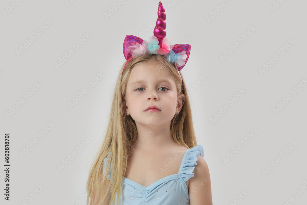 Studio portrait of beautiful bonde little girl wearing unicorn headband
Studio portrait of beautiful bonde little girl wearing unicorn headband