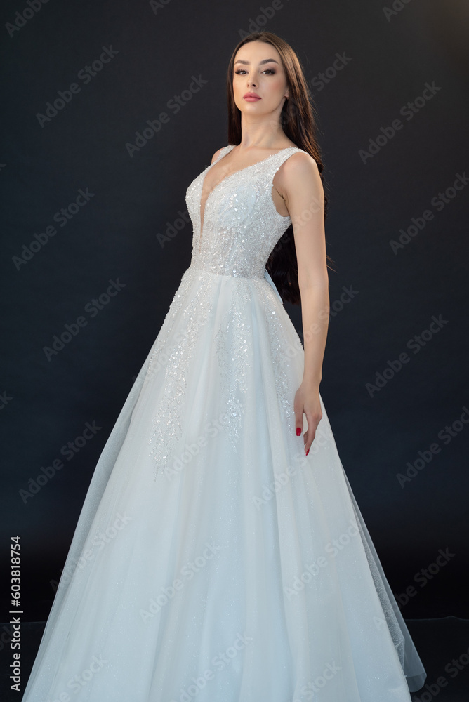 Beautiful bride in wedding dress on black background Beautiful bride in wedding dress on black background
