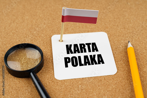 On the table is the flag of Poland, a pencil and a sheet of paper with the inscription - Polish card photo