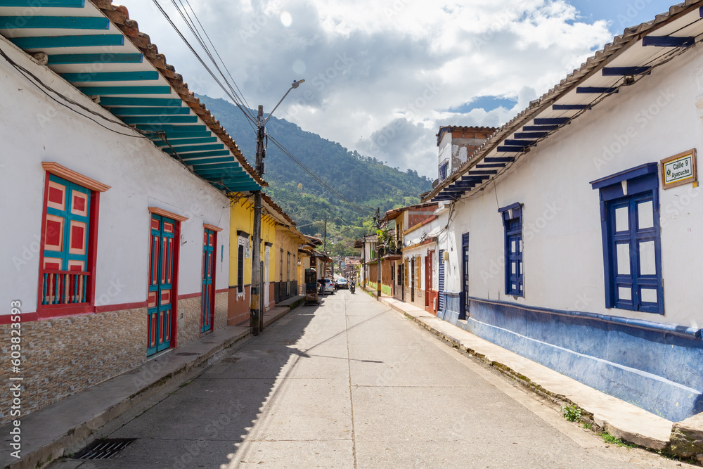Streets of a town in Colombia, where you can see people walking through colored houses. Town in the mountains of Latin America. Streets of a town in Colombia, where you can see people walking through colored houses. Town in the mountains of Latin America.