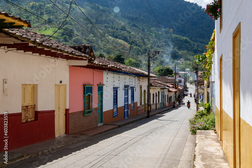 Streets of a town in Colombia  where you can see people walking through colored houses. Town in the mountains of Latin America.
