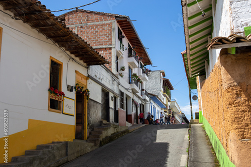 Streets of a town in Colombia, where you can see people walking through colored houses. Town in the mountains of Latin America.