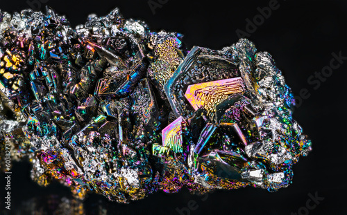 Closeup of beautiful colorful silicon carbide crystals on a black background. Iridescent synthetic carborundum detail. Use as abrasive, semiconductor or diamond gem imitation. Rare moissanite mineral. photo