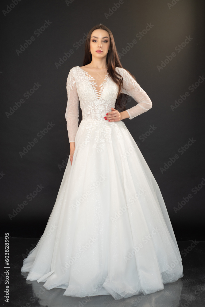 Beautiful fashion bride in wedding dress posing ob black background Beautiful fashion bride in wedding dress posing ob black background