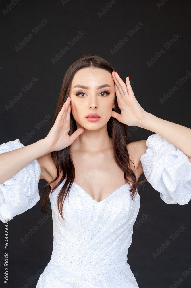 Beautiful fashion bride in wedding dress posing ob black background Beautiful fashion bride in wedding dress posing ob black background