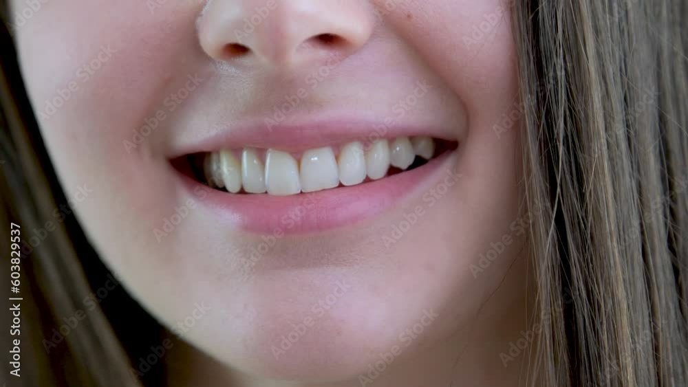 natural beauty close-up of girl's mouth smiling sincerely even white teeth frequency natural lips space for text natural beauty naturalness brown hair Smile of a charming girl with perfect white teeth natural beauty close-up of girl's mouth smiling sincerely even white teeth frequency natural lips space for text natural beauty naturalness brown hair Smile of a charming girl with perfect white teeth