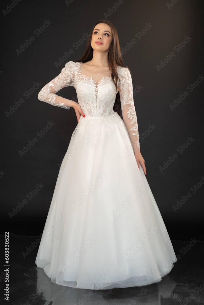 Beautiful fashion bride in wedding dress posing ob black background Beautiful fashion bride in wedding dress posing ob black background