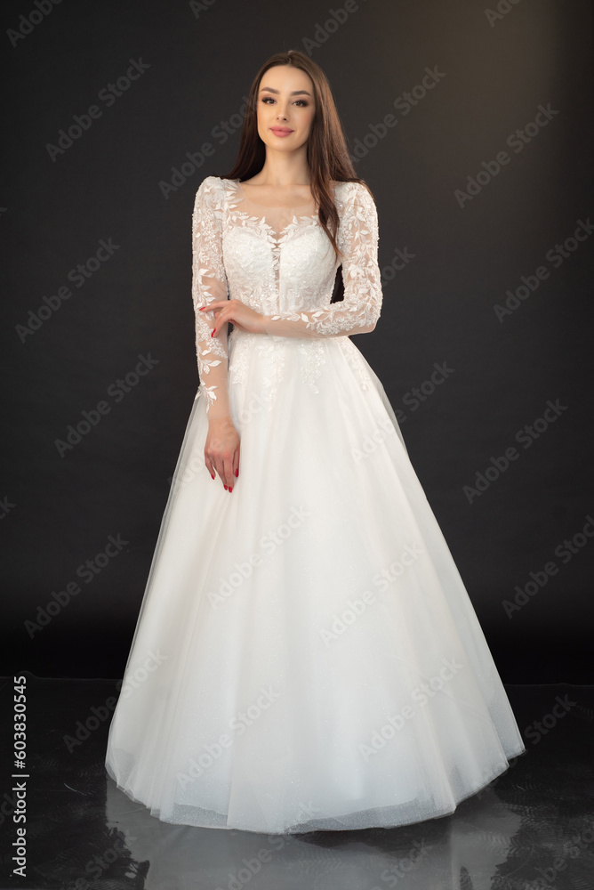 Beautiful fashion bride in wedding dress posing ob black background Beautiful fashion bride in wedding dress posing ob black background