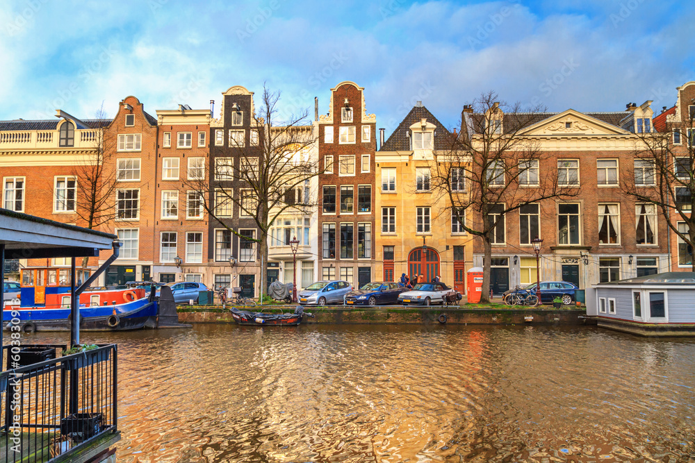 Cityscape - view of the water canal with houseboats in the historic center of Amsterdam, the Netherlands
