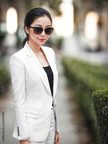 asian working woman pose for a picture at outdoor park , generative AI