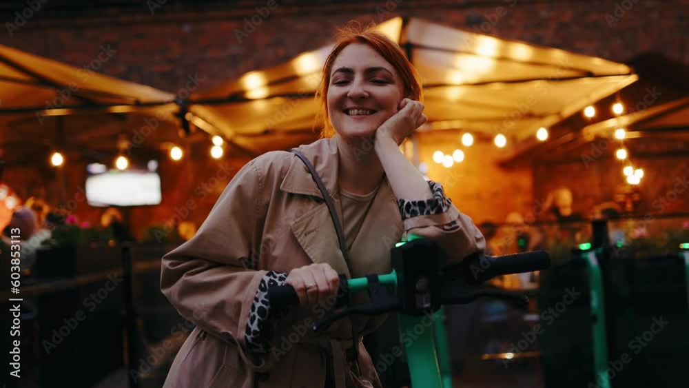Young Woman in Trench Rents Electric Scooter and Sports a Smile Young Woman in Trench Rents Electric Scooter and Sports a Smile