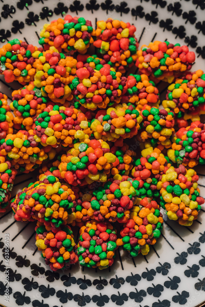 colorful clusters of candy on patterned black and white plate