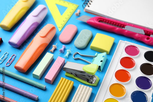 Different school stationery on light blue background. Back to school