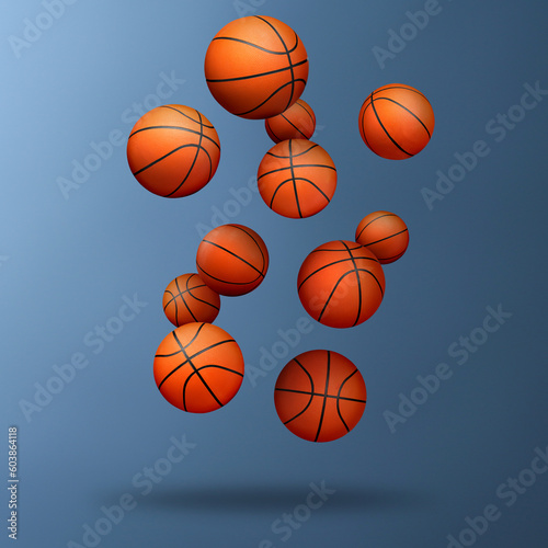 Many basketball balls falling on steel blue gradient background © New Africa