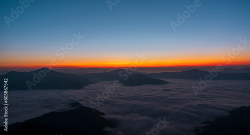 Beautiful landscape on the mountains against sky during sunrise. Spectacular view in foggy valley covered forest under morning sky. Countryside landscape view background.