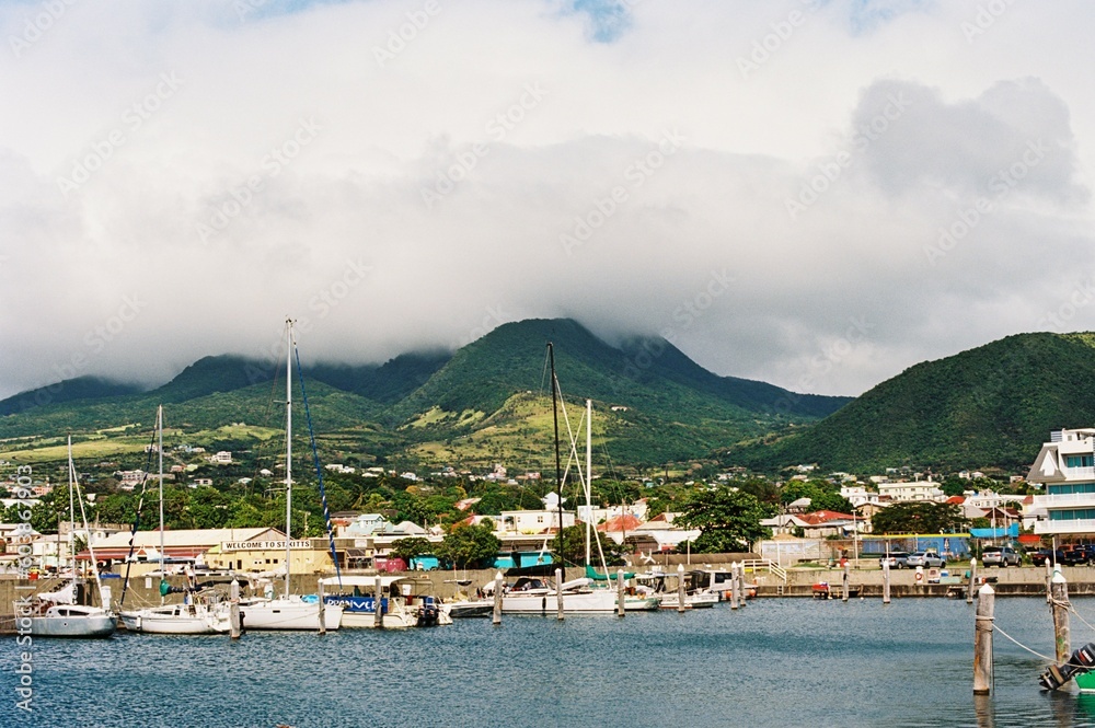 boats docked in the marina by mountains