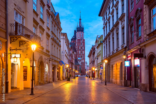 Night basilica of Saint Mary on Medieval Main market square in Old Town from Florianska street, Krakow, Poland © Kavalenkava