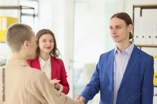 Young employee shakes hand of manager celebrating onboarding © megaflopp
