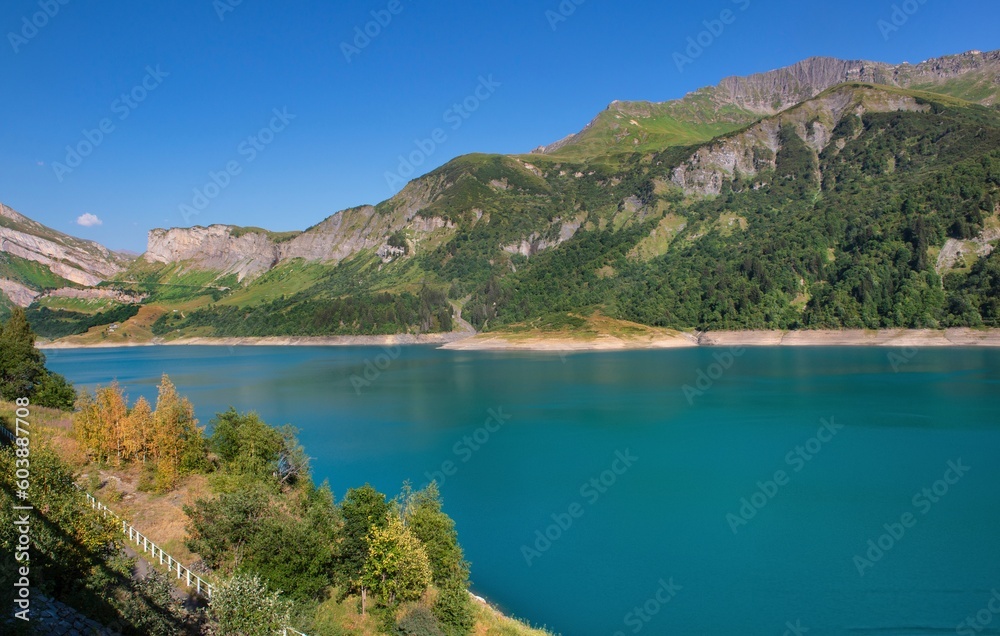 lake of Roselend and blue turquoise water borded by mountains  in french Alps under