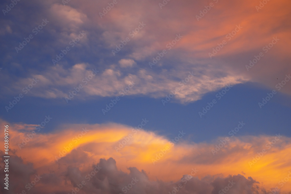 Abstract nature background. Sunset sunrise sky with yellow beautiful clouds.
