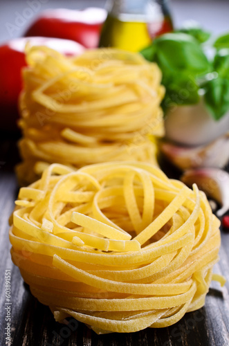 Tagliatelle yellow in dry form in the shape of a nest on a dark background